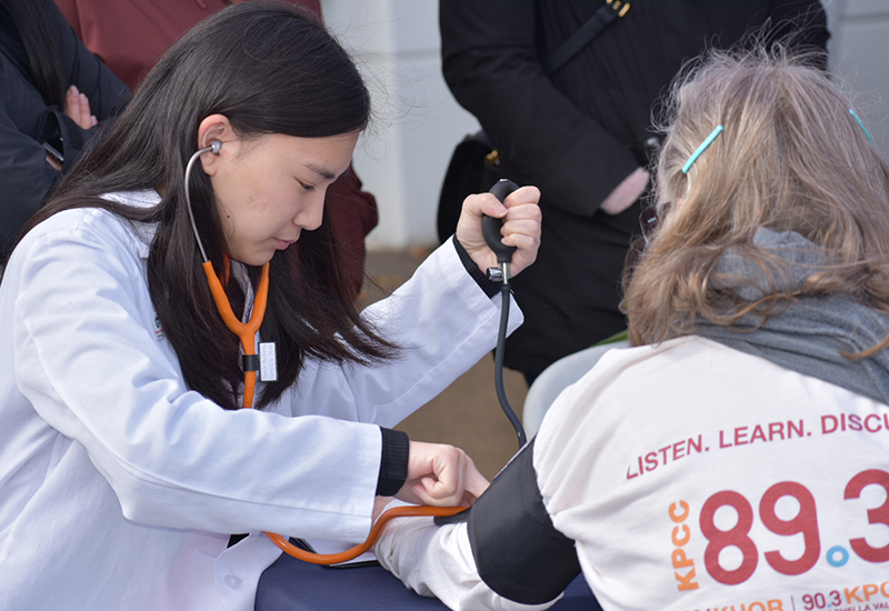 Student taking patients blood pressure